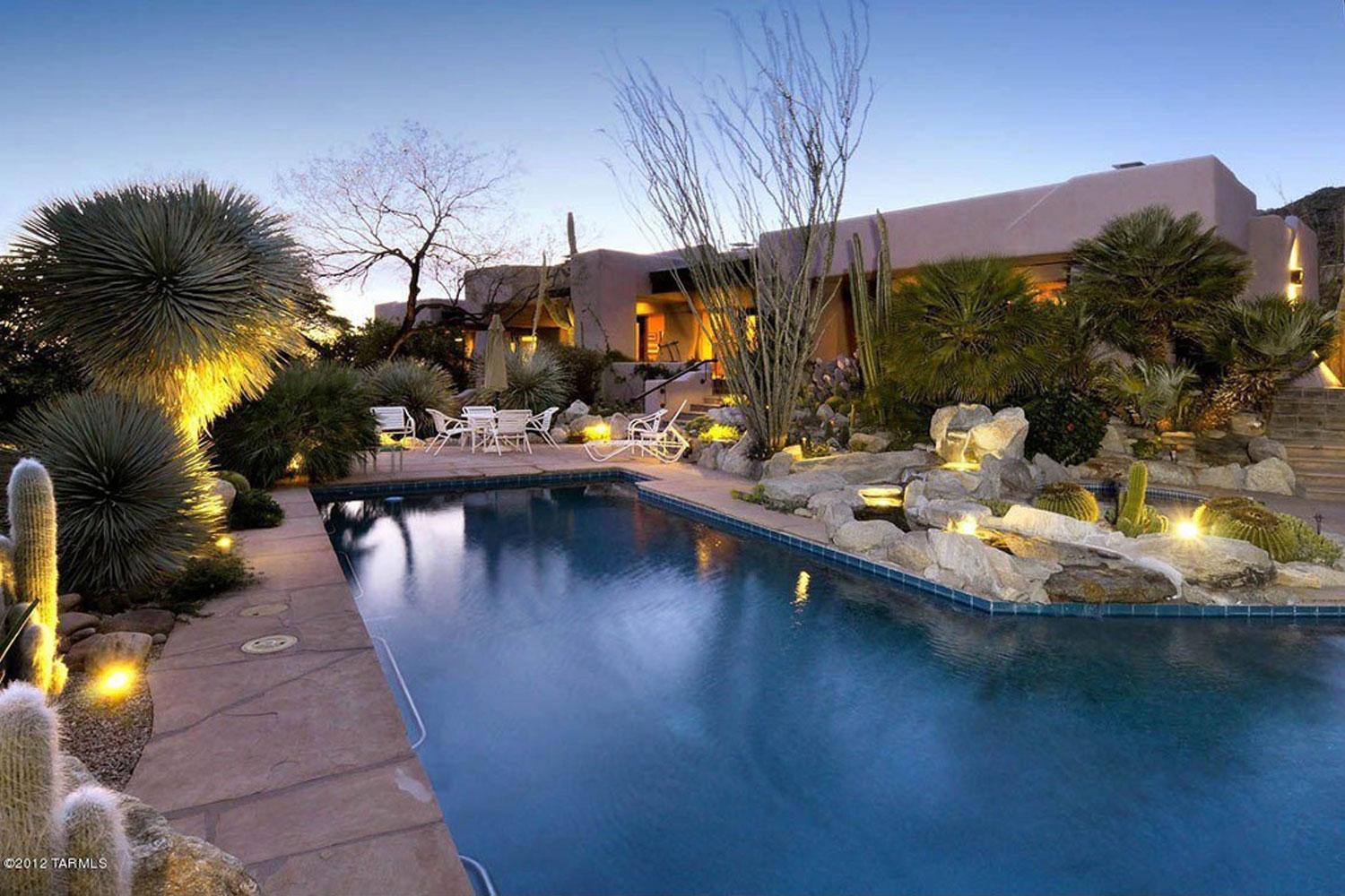 custom home exterior layout with pool and mature landscaping