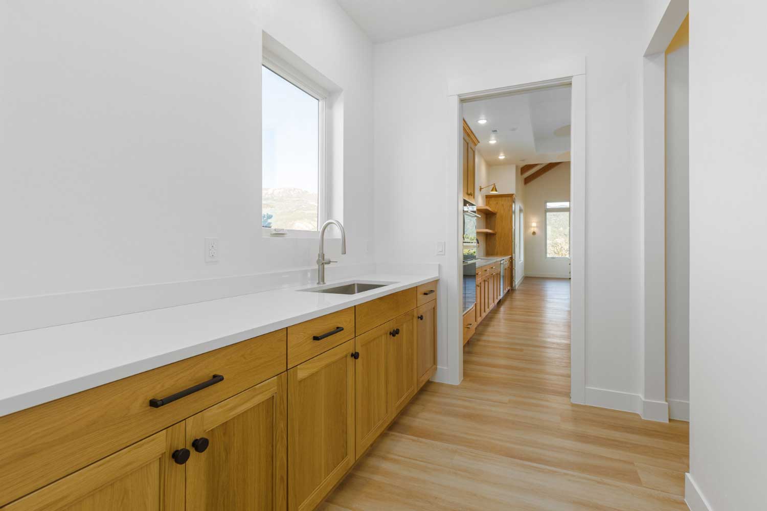 Custom cabinets and counter tops within the pantry that opens to the kitchen